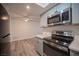 Modern kitchen features stainless steel appliances, sleek countertops, and ample cabinet space at 2430 Old Forge Ln # 106, Las Vegas, NV 89121