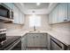 Updated kitchen featuring new gray cabinets and stainless steel appliances at 2430 Old Forge Ln # 106, Las Vegas, NV 89121