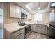 Modern kitchen featuring gray cabinets and stainless steel appliances at 2430 Old Forge Ln # 106, Las Vegas, NV 89121