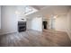 Bright living room featuring modern flooring and cozy fireplace with a loft overlooking the space at 2430 Old Forge Ln # 106, Las Vegas, NV 89121