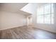 Bright living room boasts large windows, modern lighting, and wood-look flooring at 2430 Old Forge Ln # 106, Las Vegas, NV 89121
