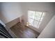 View of living room from staircase featuring high ceilings and large window at 2430 Old Forge Ln # 106, Las Vegas, NV 89121