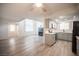 Living space with fireplace, gray cabinets, stainless appliances, and wood-look floors at 2430 Old Forge Ln # 106, Las Vegas, NV 89121