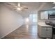 Open-concept living space featuring wood-look floors and plenty of natural light at 2430 Old Forge Ln # 106, Las Vegas, NV 89121