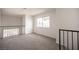 Open loft showcasing natural light, neutral carpeting and railings at 2430 Old Forge Ln # 106, Las Vegas, NV 89121