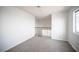 An open loft space with neutral carpeting and a bright window at 2430 Old Forge Ln # 106, Las Vegas, NV 89121