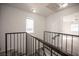 A carpeted staircase with iron railing leads to the upper level of the home at 2430 Old Forge Ln # 106, Las Vegas, NV 89121