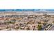 Expansive daytime aerial view of a residential community with rooftops stretching toward the Las Vegas skyline at 2824 Soaring Peak Ave, Henderson, NV 89052