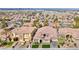 High-angle view of neighborhood homes featuring well-manicured lawns and mature trees at 2824 Soaring Peak Ave, Henderson, NV 89052