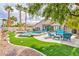 Gorgeous backyard with a sparkling pool, spa, lush landscaping, and an inviting patio area at 2824 Soaring Peak Ave, Henderson, NV 89052