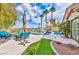 Inviting backyard with a patio, comfortable seating, a pool, and lush landscaping for outdoor living at 2824 Soaring Peak Ave, Henderson, NV 89052