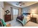 Comfortable bedroom features a ceiling fan and plantation shutters on the window at 2824 Soaring Peak Ave, Henderson, NV 89052