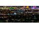 Stunning nighttime view of the vibrant Las Vegas city lights from a high vantage point overlooking residential rooftops at 2824 Soaring Peak Ave, Henderson, NV 89052