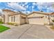 Charming single-story home with a well-manicured lawn, two-car garage, and desert landscaping at 2824 Soaring Peak Ave, Henderson, NV 89052