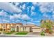 Charming single-story home with a well-manicured lawn and a two-car garage at 2824 Soaring Peak Ave, Henderson, NV 89052