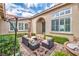 Inviting front patio area features stylish outdoor furniture and a serene fountain, creating a relaxing space at 2824 Soaring Peak Ave, Henderson, NV 89052