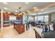 Well-equipped kitchen open to a living area, featuring stainless steel appliances and island seating at 2824 Soaring Peak Ave, Henderson, NV 89052