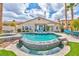 Backyard oasis features a sparkling pool, spa, lush landscaping, and an outdoor seating area at 2824 Soaring Peak Ave, Henderson, NV 89052