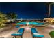 Relaxing backyard pool with luxurious lounge chairs and a breathtaking view of the city skyline at night at 2824 Soaring Peak Ave, Henderson, NV 89052