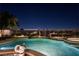 Nighttime view of a beautiful pool and spa with city views in the background at 2824 Soaring Peak Ave, Henderson, NV 89052