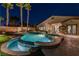 Night view of backyard pool and spa featuring manicured landscaping and ambient lighting at 2824 Soaring Peak Ave, Henderson, NV 89052