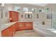 Bright bathroom with dual vanity, granite countertop, soaking tub, and natural light from multiple windows at 2905 Haddon Dr, Las Vegas, NV 89134
