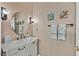 Charming bathroom with oval mirror, decorative lighting, artwork, and stylish towel hooks at 2905 Haddon Dr, Las Vegas, NV 89134