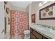 Well-lit bathroom features a shower with patterned curtain and decorative wall plates at 2905 Haddon Dr, Las Vegas, NV 89134