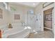 Bright bathroom with a soaking tub, frameless shower and decorative touches around the room at 2905 Haddon Dr, Las Vegas, NV 89134
