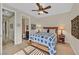 Comfortable bedroom featuring a ceiling fan and view into ensuite bath at 2905 Haddon Dr, Las Vegas, NV 89134