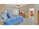 Spacious bedroom has a ceiling fan, carpeting, and a queen bed with blue bedding at 2905 Haddon Dr, Las Vegas, NV 89134