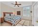 Cozy bedroom with a ceiling fan, shuttered window, and a comfortable bed with a blue and white patterned quilt at 2905 Haddon Dr, Las Vegas, NV 89134
