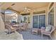 Covered patio complete with wicker furniture and ceiling fan, perfect for outdoor entertaining at 2905 Haddon Dr, Las Vegas, NV 89134