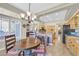 Bright kitchen features tile floors, granite counters, an island, and dining nook with plantation shutters at 2905 Haddon Dr, Las Vegas, NV 89134