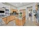 Eat-in kitchen with granite countertops and backsplash, wood cabinetry, and an island with barstool seating at 2905 Haddon Dr, Las Vegas, NV 89134