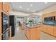 Gourmet kitchen featuring an island with a sink, granite countertops, tile floors, and built-in appliances at 2905 Haddon Dr, Las Vegas, NV 89134