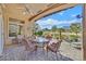Relaxing covered patio features pavers, ceiling fan, and ample seating overlooking the green backyard at 2905 Haddon Dr, Las Vegas, NV 89134