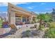 Outdoor patio featuring lounge chairs, dining table, covered area, and lush landscaping at 2905 Haddon Dr, Las Vegas, NV 89134