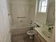 Well-lit bathroom boasts a tub, toilet, sink, vanity, and medicine cabinet at 3100 Gladstone Ct, Las Vegas, NV 89134