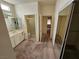 Bright bathroom featuring a double sink vanity, toilet, and walk-in shower at 3100 Gladstone Ct, Las Vegas, NV 89134