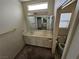 Bathroom featuring double sinks with large mirrors, a vanity, and a separate toilet area at 3100 Gladstone Ct, Las Vegas, NV 89134