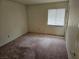 Simple bedroom with neutral walls, a window, and neutral carpeting at 3100 Gladstone Ct, Las Vegas, NV 89134