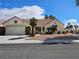 Charming single-story home featuring desert landscaping, a red tile roof, and an attached two-car garage at 3100 Gladstone Ct, Las Vegas, NV 89134