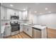 Kitchen with stainless steel appliances, white cabinets, and an island with barstool seating at 3104 Waterview Dr, Las Vegas, NV 89117