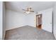Bedroom featuring carpet, ceiling fan, and door to adjacent room at 3125 N Buffalo Dr # 1136, Las Vegas, NV 89128