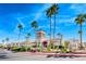 Elegant community building with desert landscaping, palm trees, and a stucco facade beneath a bright blue sky at 3125 N Buffalo Dr # 1136, Las Vegas, NV 89128