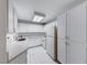 The kitchen boasts white cabinets, neutral countertops, a double basin sink, and a tile floor at 3125 N Buffalo Dr # 1136, Las Vegas, NV 89128
