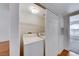 Efficient laundry area tucked away with white washer and dryer, featuring convenient shelving for storage at 3125 N Buffalo Dr # 1136, Las Vegas, NV 89128