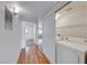 Convenient laundry closet with washer and dryer, easily accessible off the hallway with wood-look flooring at 3125 N Buffalo Dr # 1136, Las Vegas, NV 89128