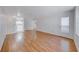 Inviting open-plan living room showcasing pristine wood floors, neutral walls, and an open view into the kitchen at 3125 N Buffalo Dr # 1136, Las Vegas, NV 89128